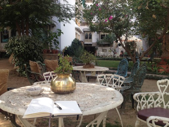 At our hotel, in the courtyard, updating my travel journal.